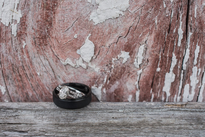 A close up shot of two wedding rings on a wooden background