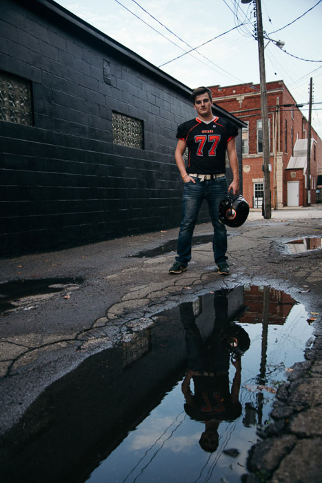 A young man in sports gear posing outdoors