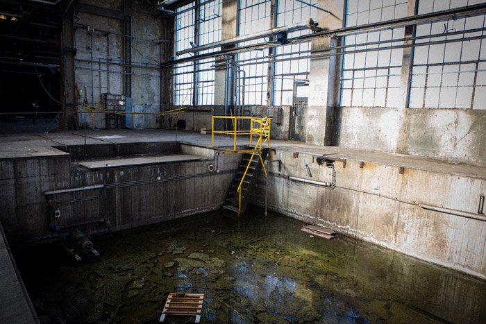 An industrial photography shot of a waste pool inside a building