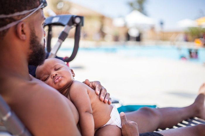 A father and son relaxing at a swimming pool - party photos