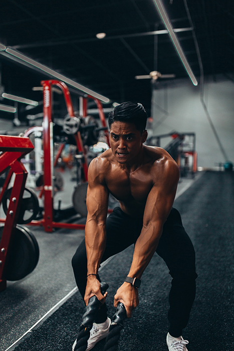 A man lifting weights in the gym for a fitness photoshoot