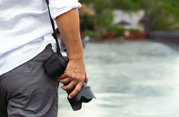 Man with a photo camera in sunlight.
