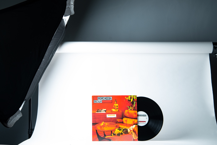 Vinyl record against a white background illuminated from the side