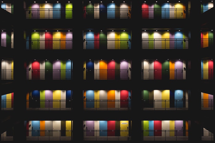 Repetition in photography: Repeating patterns of colored doors in the inner courtyard of an apartment building