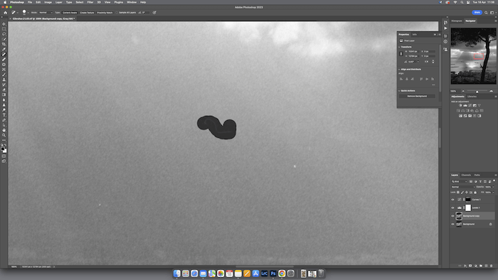 A software program is open and active on a computer screen with a partially obscured image of a storm.