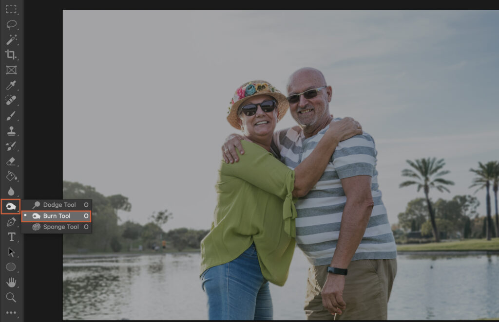 An elderly couple embracing at a lake, with a software interface overlaying the image.