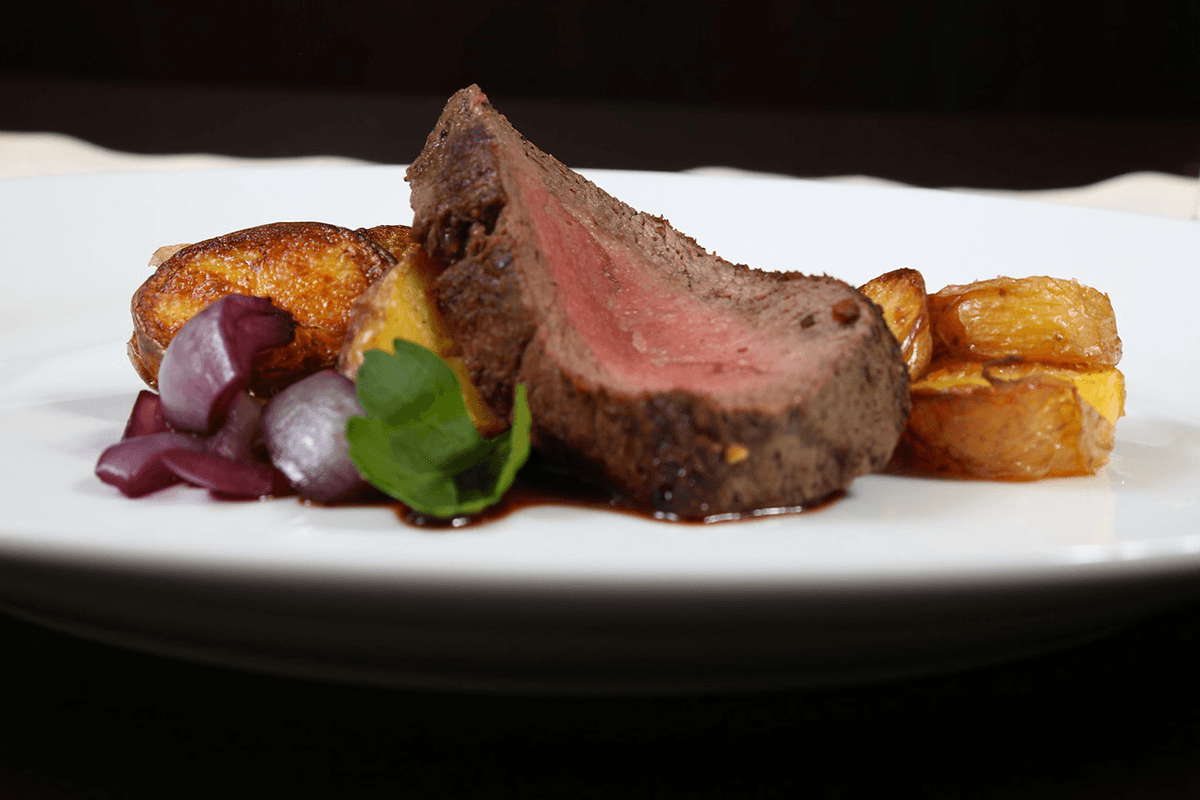 A stylish photo of a beef and vegetable dish