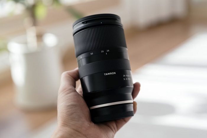 Tamron lens in a mans hand